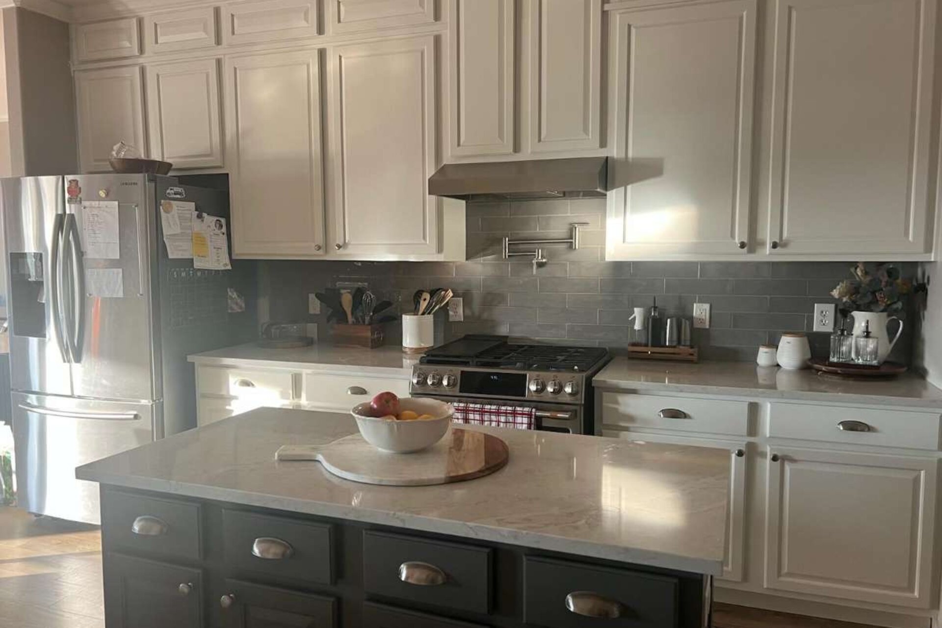 Custom quartz kitchen island with waterfall edge and dark cabinetry, a Babri Stone installation