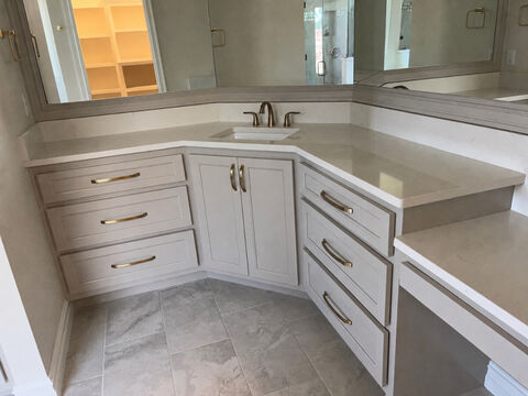 Corner bathroom vanity with quartz countertop and brass hardware